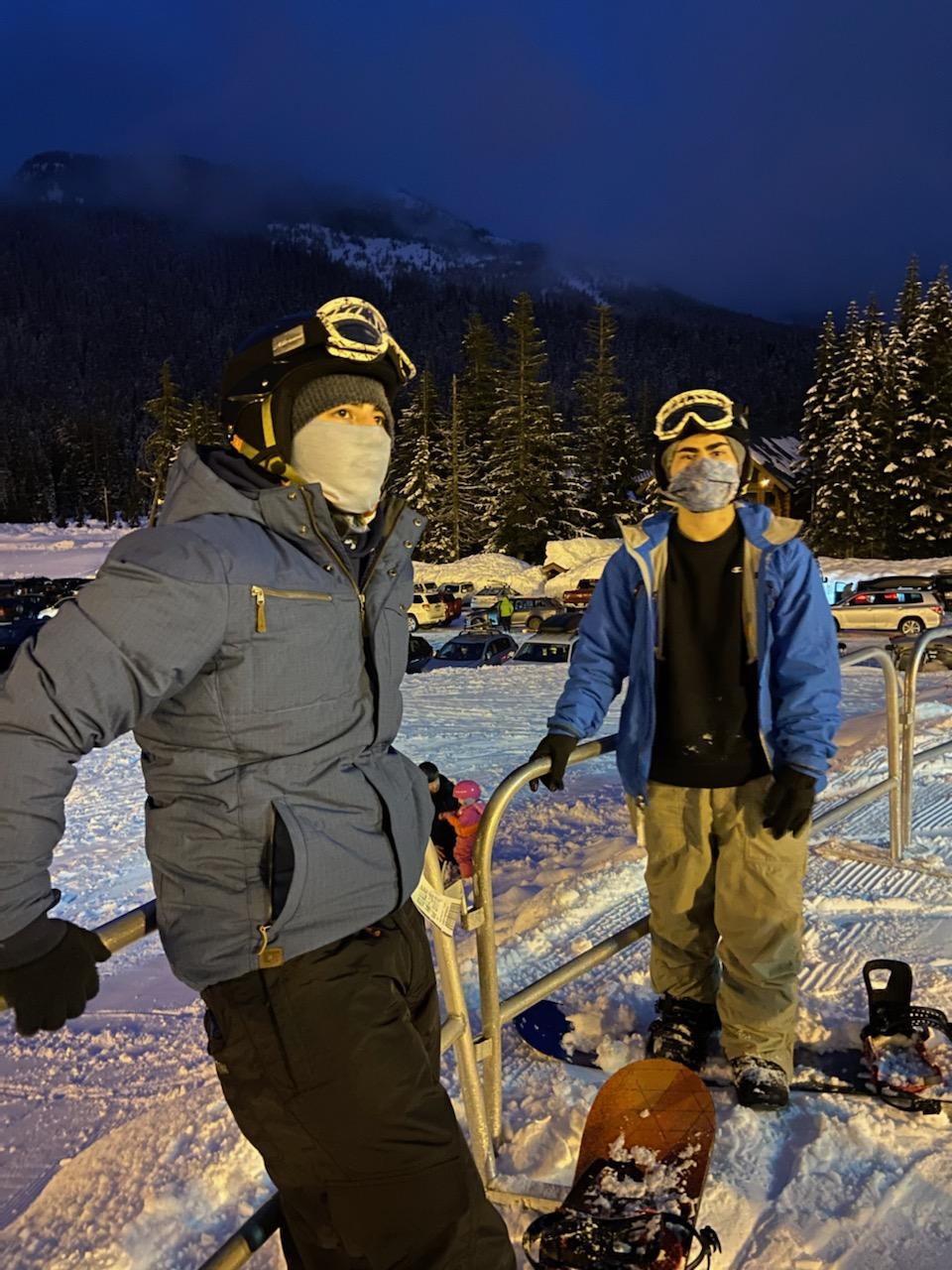 Woodinville youth standing in the snow wearing snowboarding gear. 