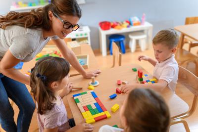 Caregiver with children in a classroom