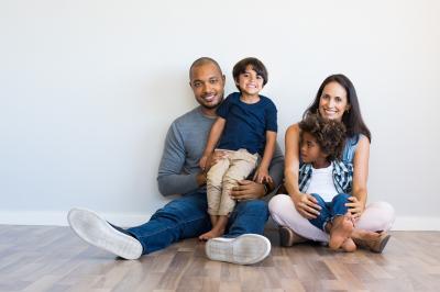 Family sitting on floor with camera