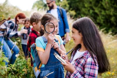 Group of school children with teacher on field trip in nature