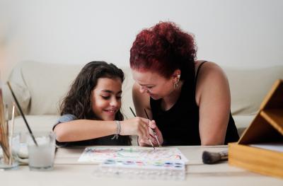 Latin mother and child painting with water colors