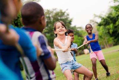 Children playing tug of war in a park