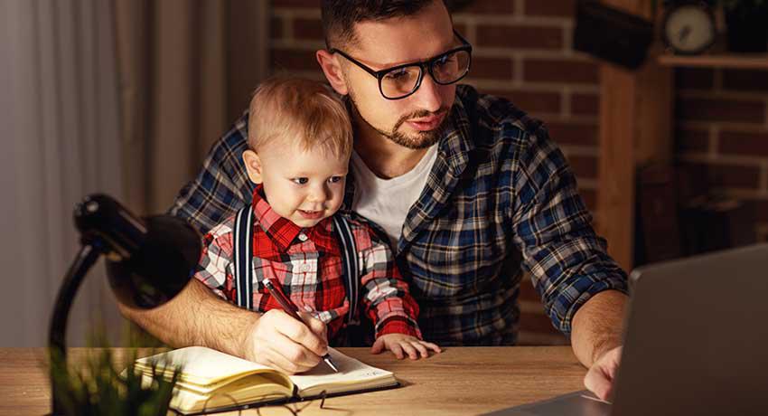 father with son looking at computer