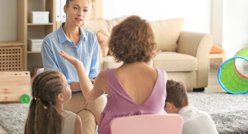 Provider talking with mother and children