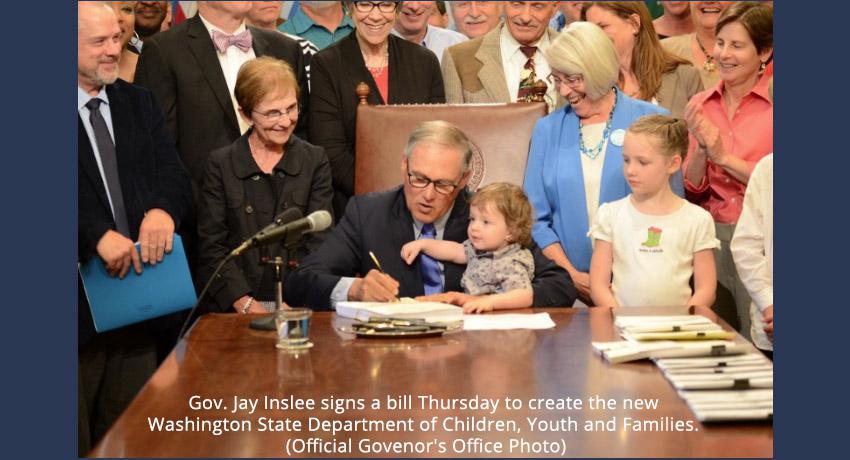 Governor Inslee signing document