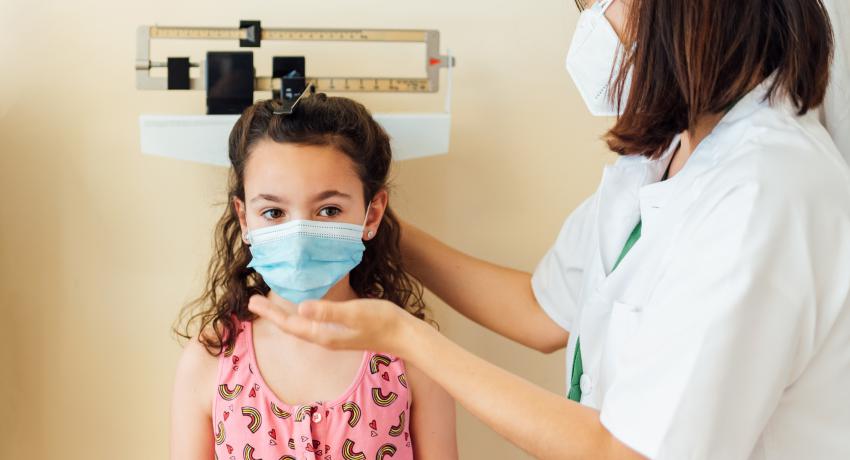 little girl getting height measured by nurse