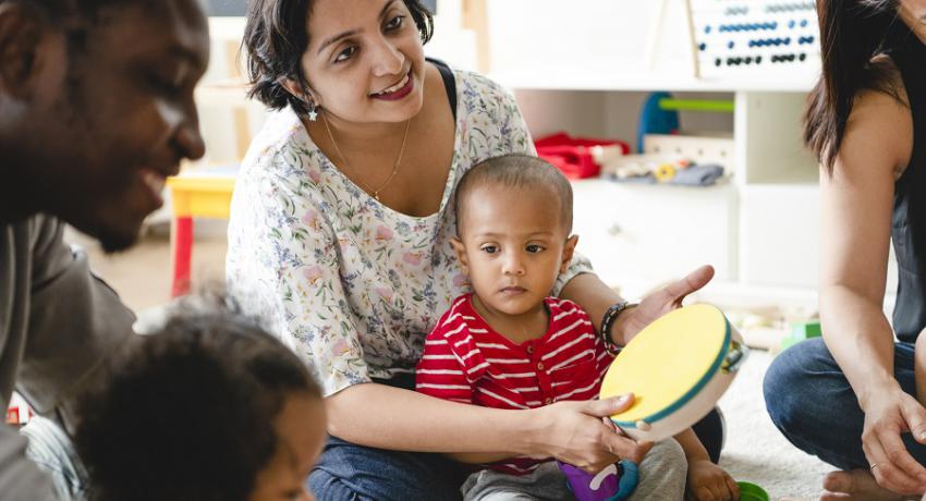 Parents interact with children in preschool setting. 