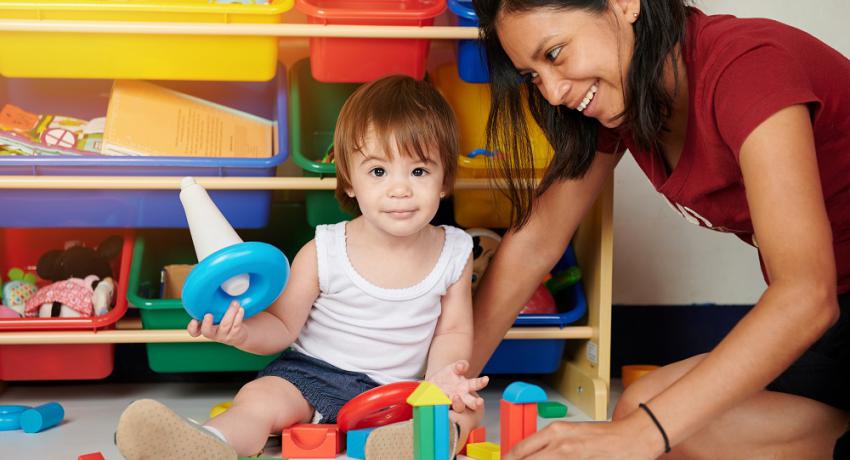 Young child with caregiver in child care setting. 