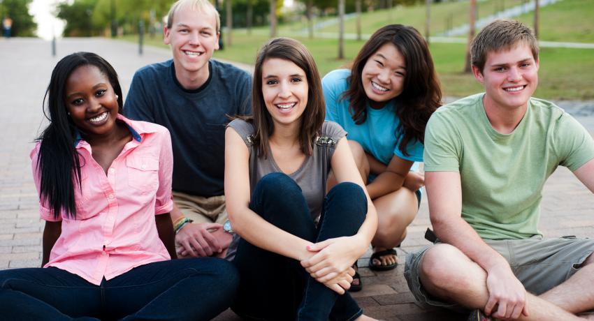 Youth hanging out together outdoors. 