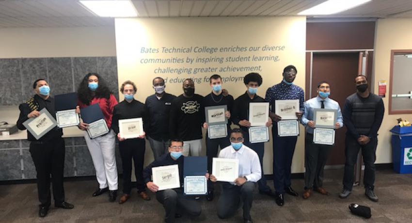 Graduating youth proudly display their certificates of completion. 