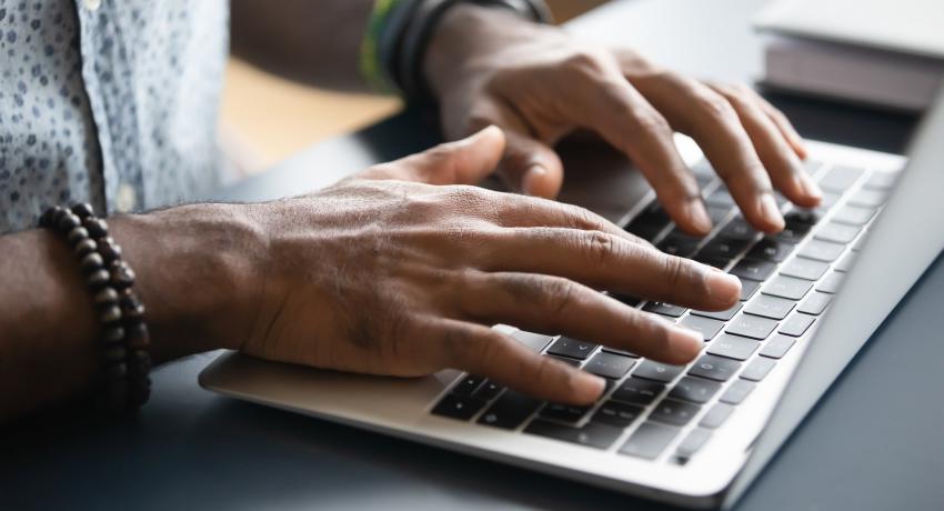 Person typing on a computer.