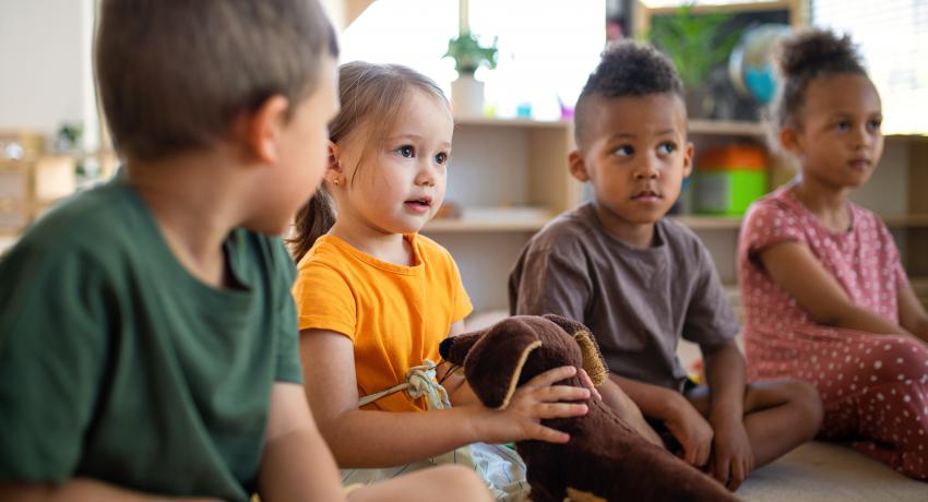 A group of diverse children sitting together.