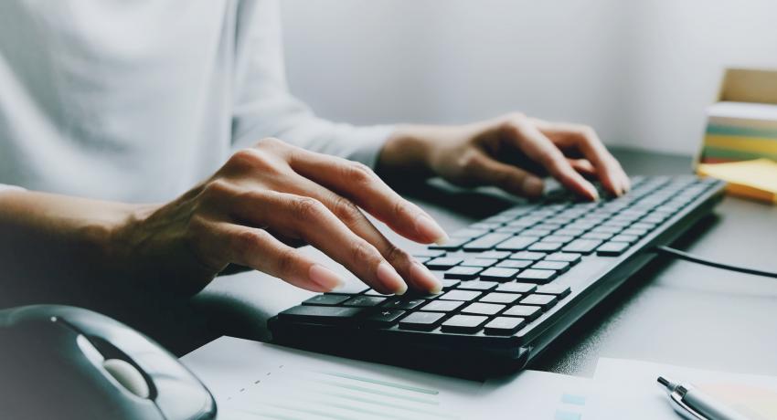 Person typing at a desk