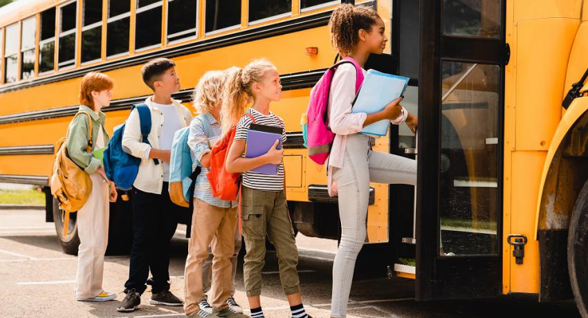 Kids getting on the bus for school