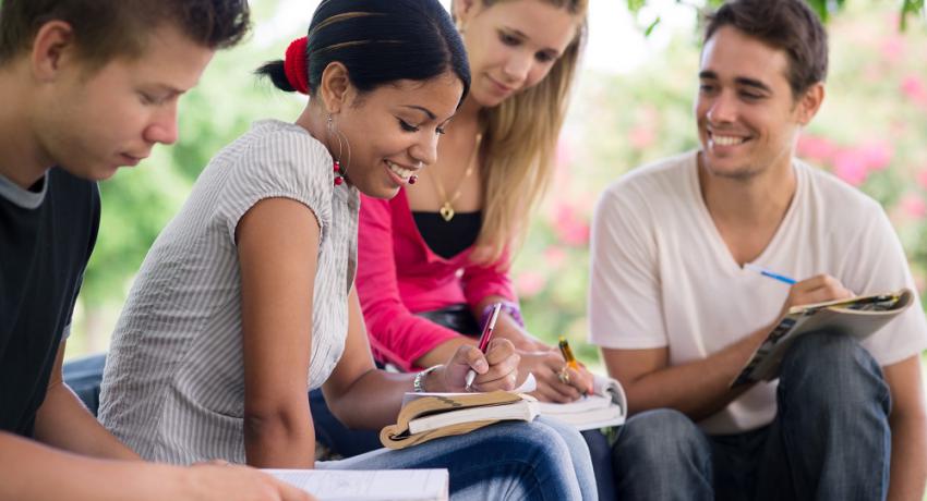 Students writing in the park