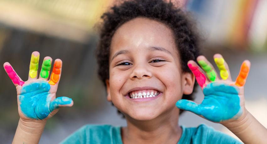 Happy child with painted hands