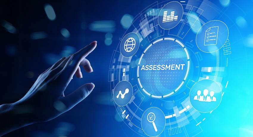 Digital screen, "Assessment" text encircled by menu options, person's hand ready to select option