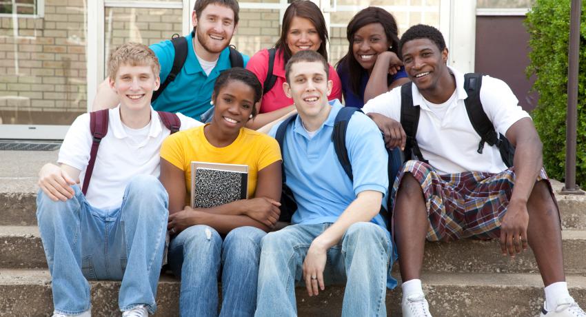 Teens at steps of school