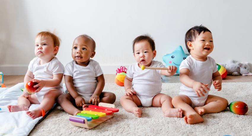 Four babies play together. 