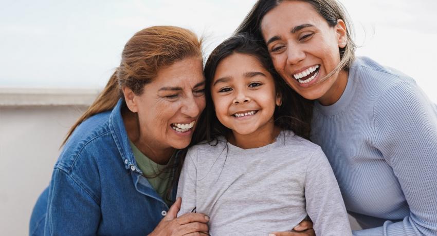 Happy latin multi generation family have tender moment together outdoor